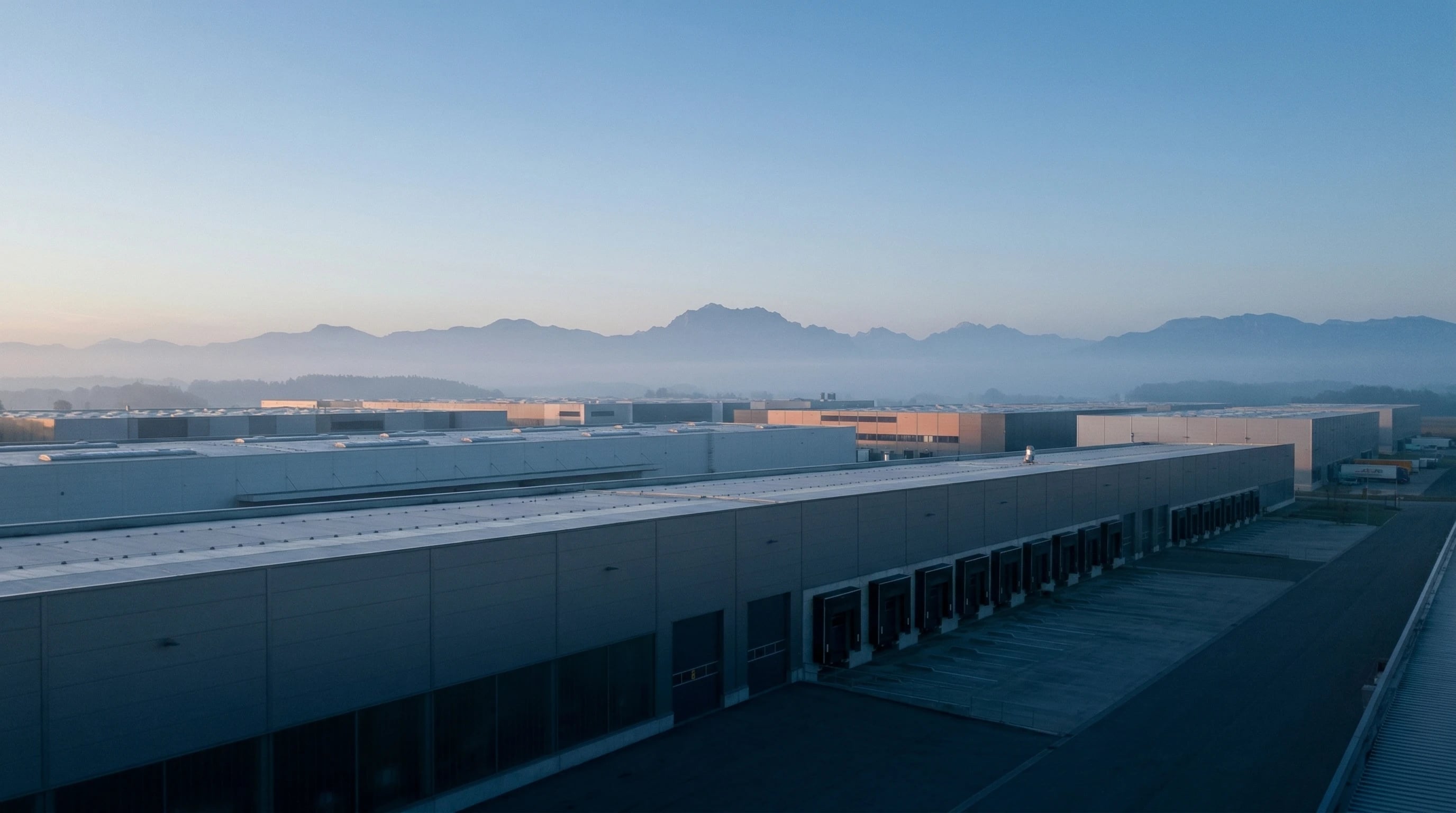 Modern logistics facility near Munich with Bavarian Alps in the distance